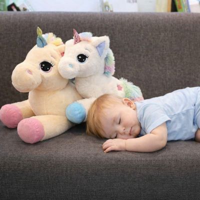 Bébé repose avec peluche licorne confortable